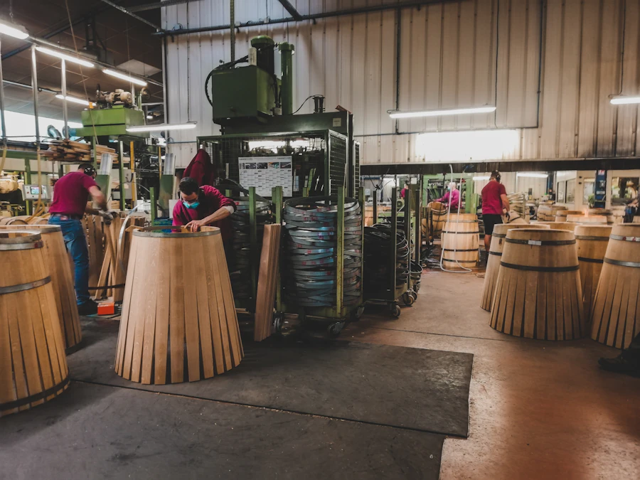 Workers operating production machinery in a corrugated box manufacturing facility in India for export orders