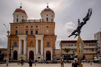 a statue of a bird in front of a church