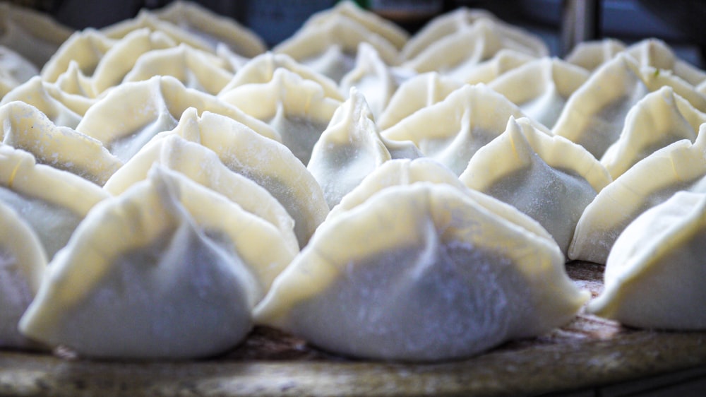 a tray of dumplings sitting on top of a table