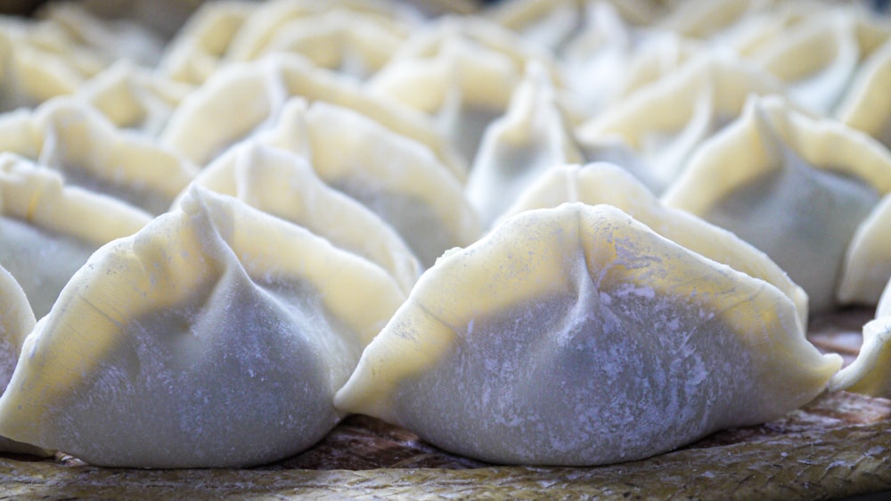 a close up of some dumplings on a tray