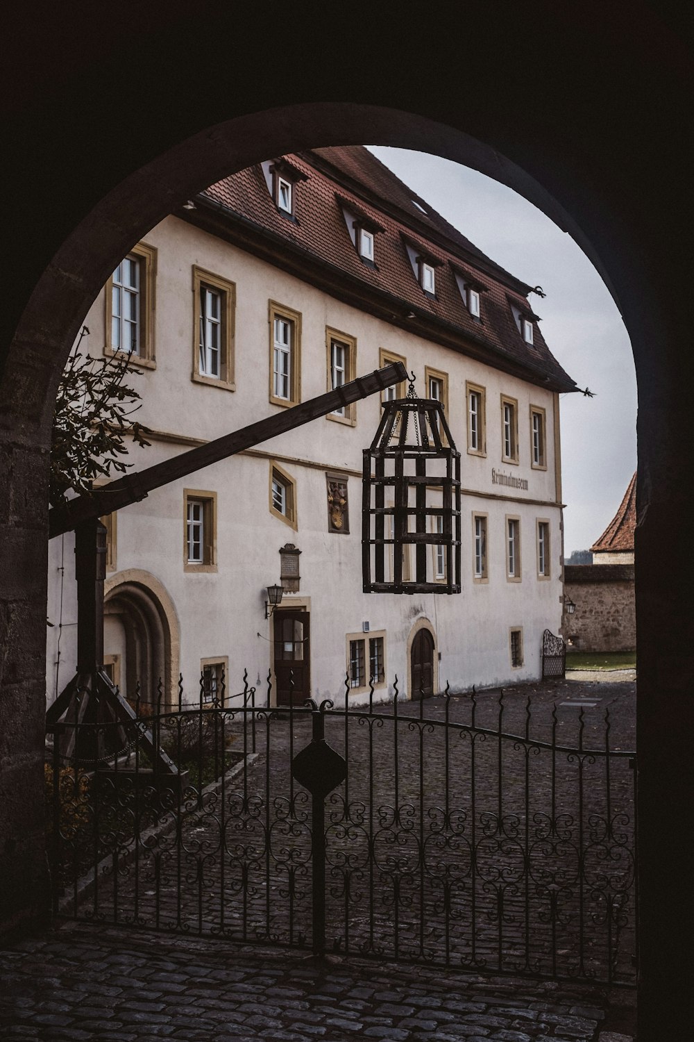 a large white building with a black gate