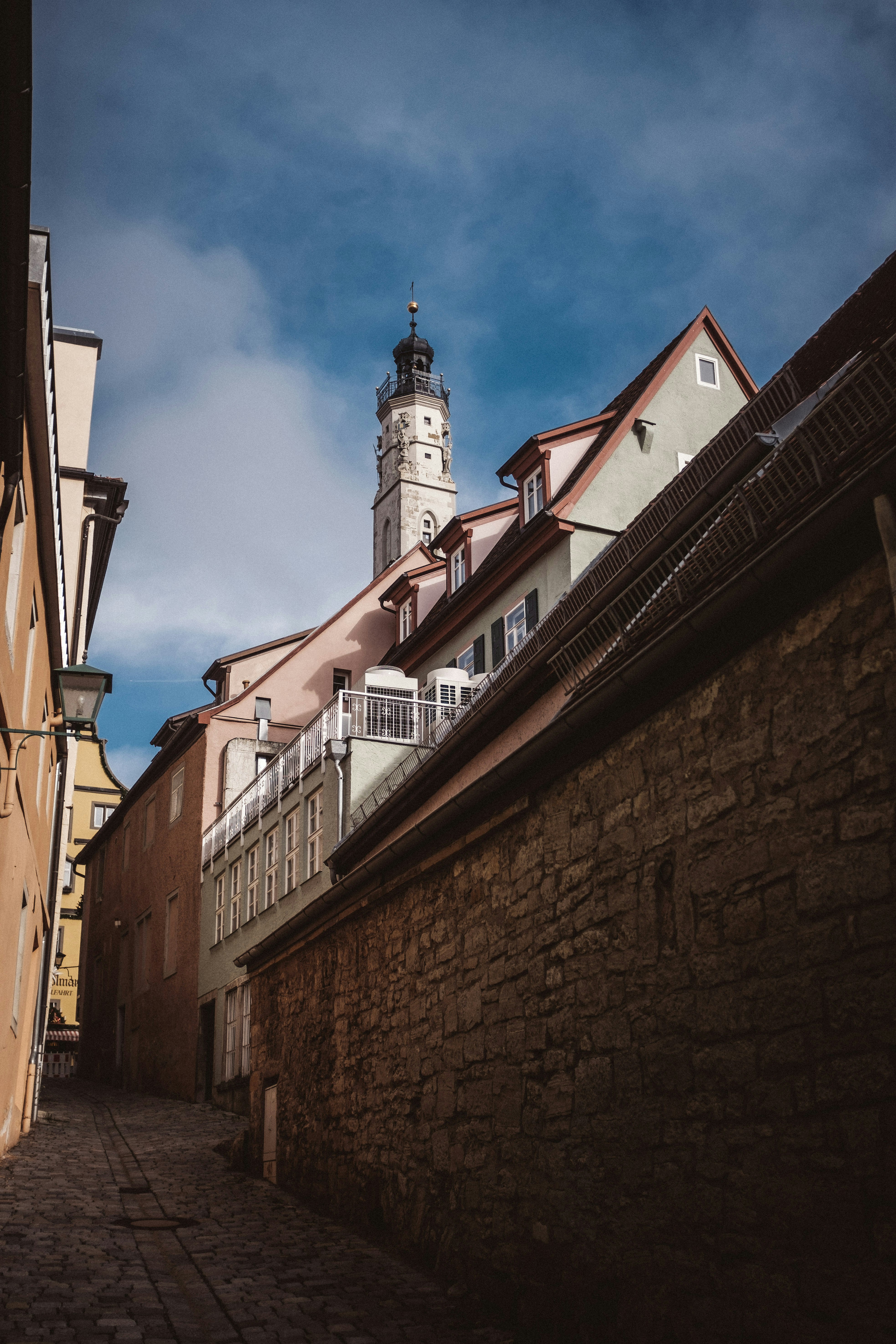 a clock tower towering over a city street