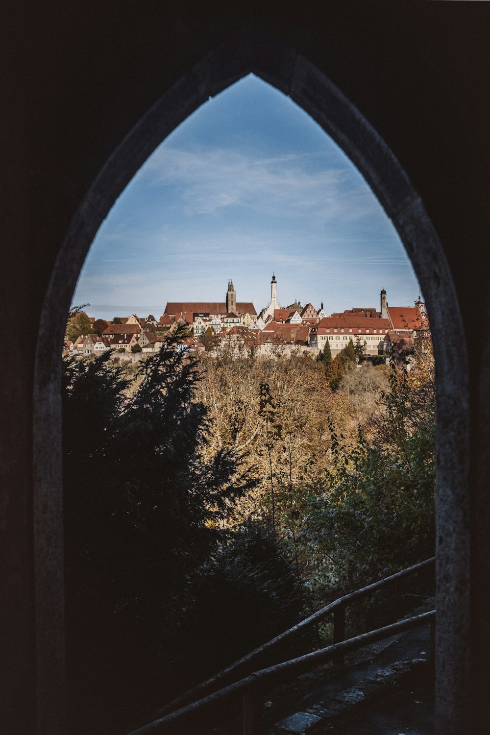 a view of a city through an arch in a building