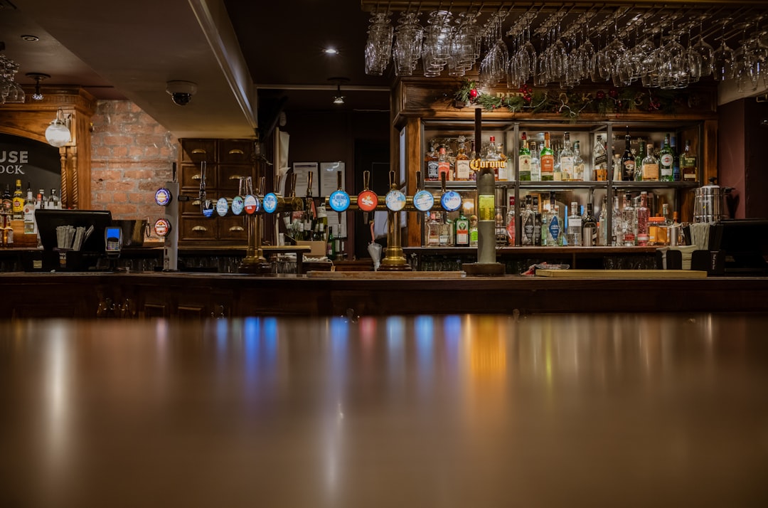a dimly lit bar with lots of liquor bottles, Pub Bar