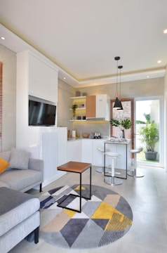 a living room filled with furniture and a flat screen tv