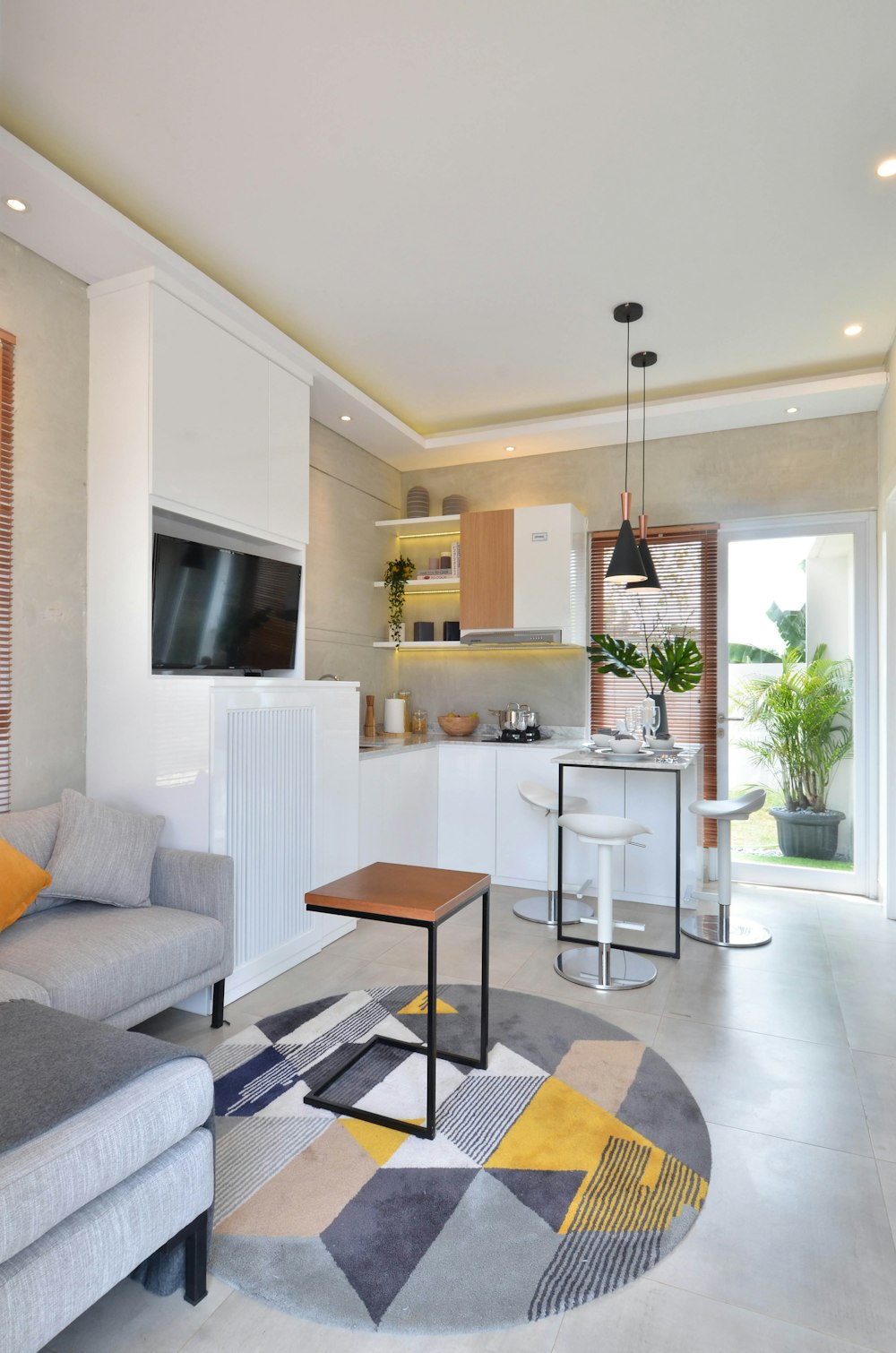 a living room filled with furniture and a flat screen tv