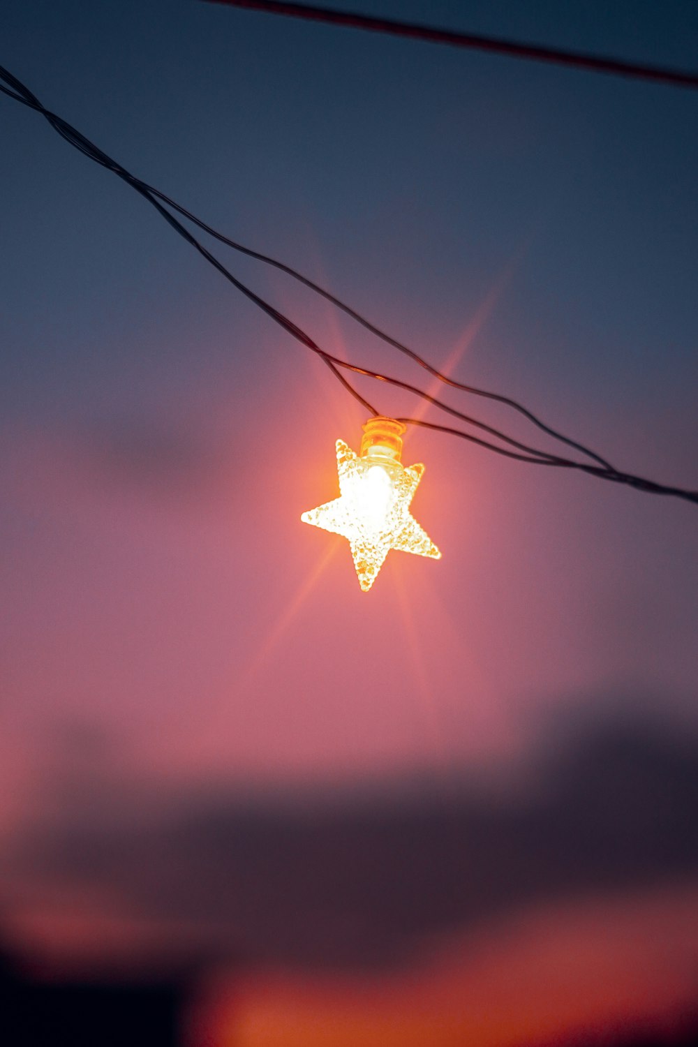 a star of david hanging from a power line