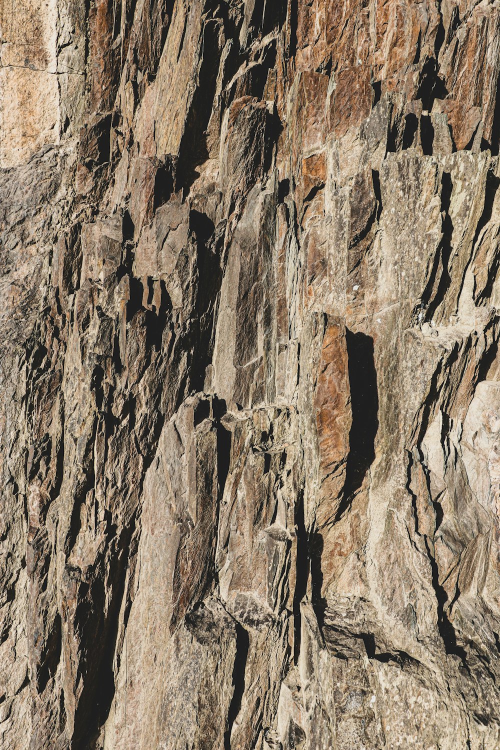 a man climbing up the side of a mountain