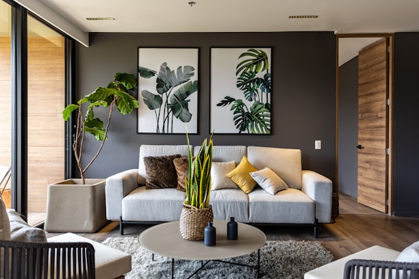 a living room filled with furniture and a potted plant