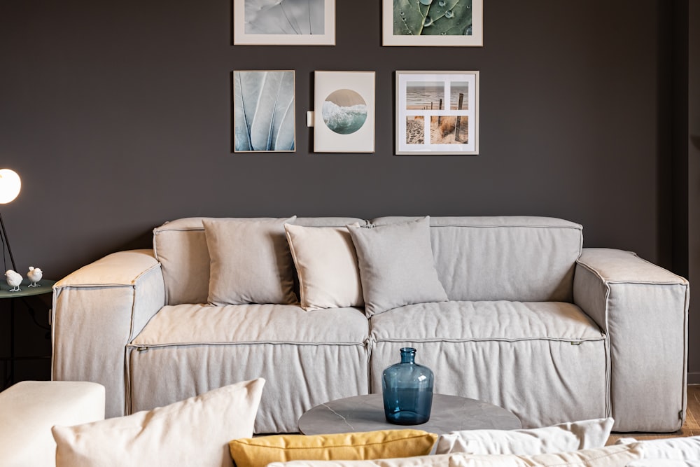 a living room filled with furniture and pictures on the wall