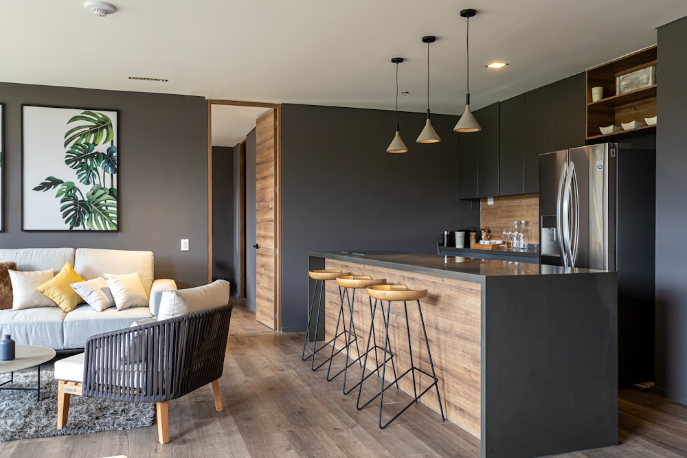 a living room with a couch a table and a refrigerator