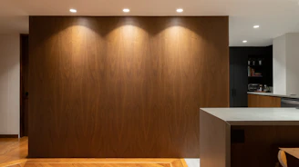 Modern kitchen interior featuring anthracite panels with warm LED lighting accents.