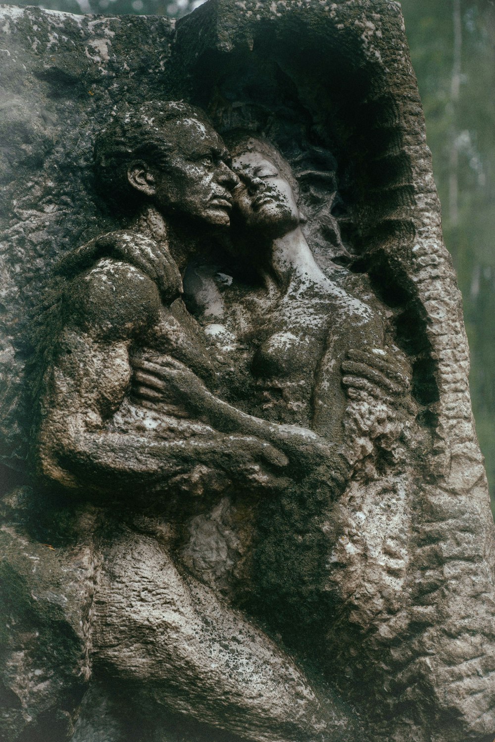 a statue of a man holding a woman