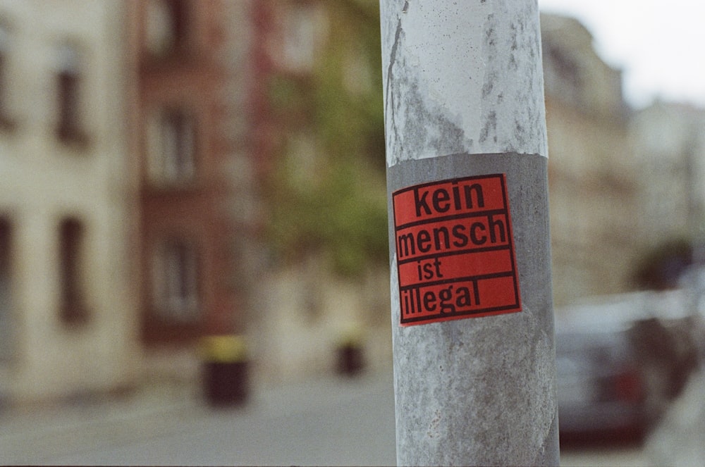 a sticker on a pole on a city street