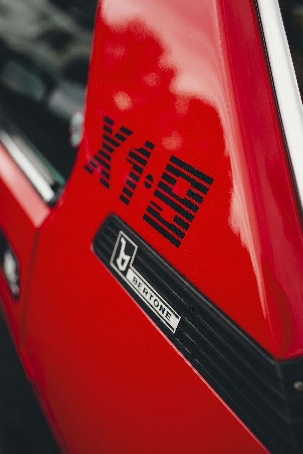 a close up of the emblem on a red sports car