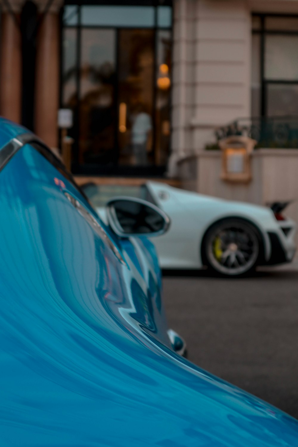 a blue car parked in front of a building