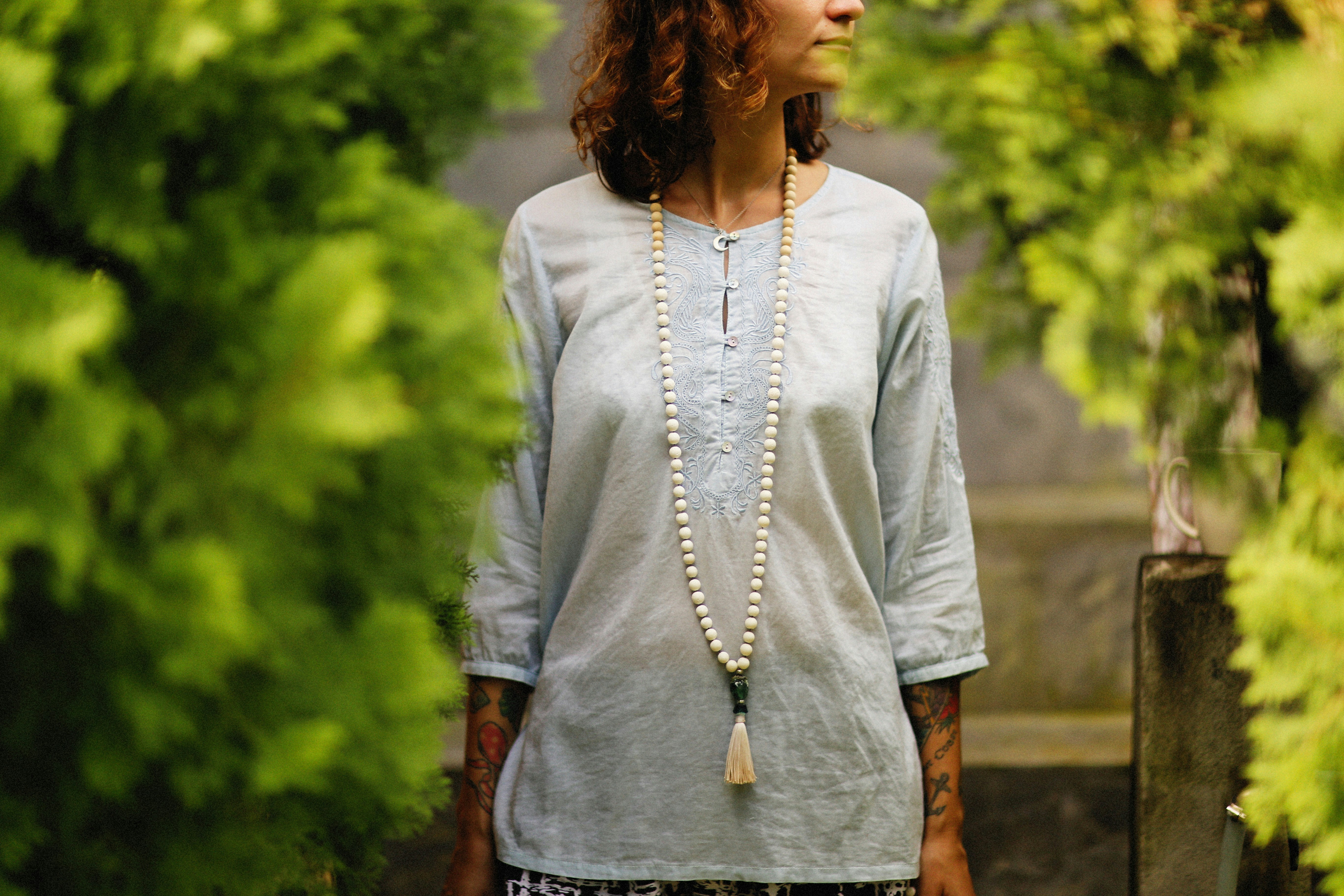 a woman standing in front of some trees