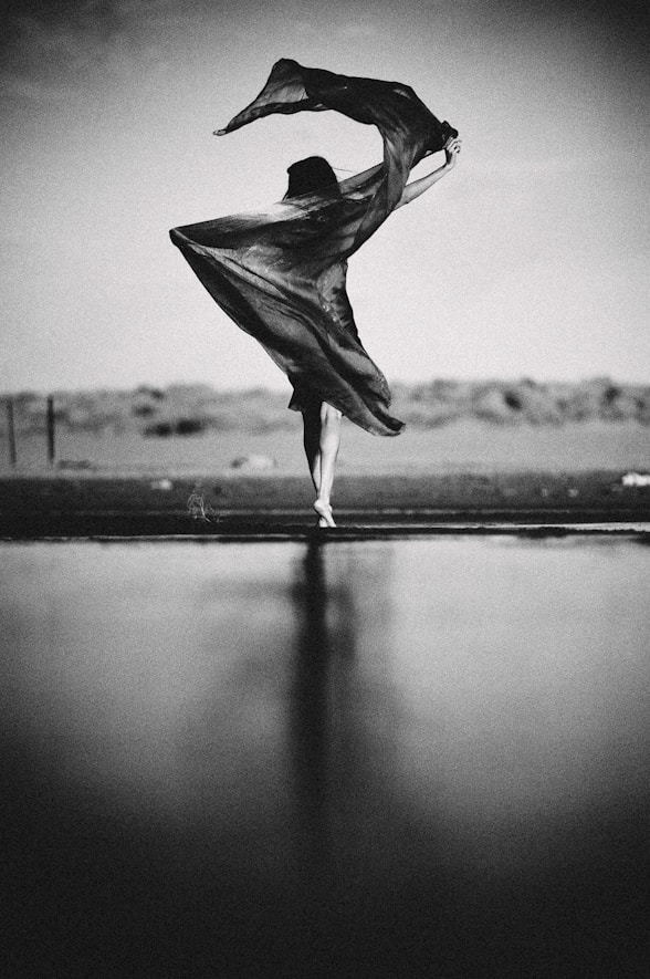 a black and white photo of a woman dancing
