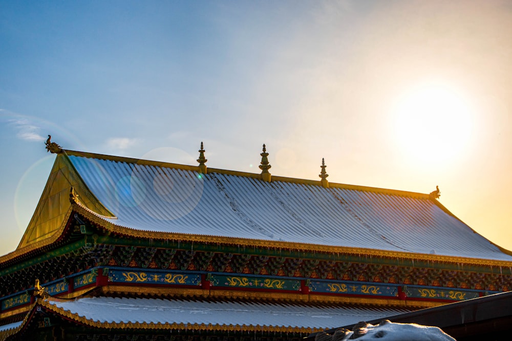 the roof of a building with a sun in the background