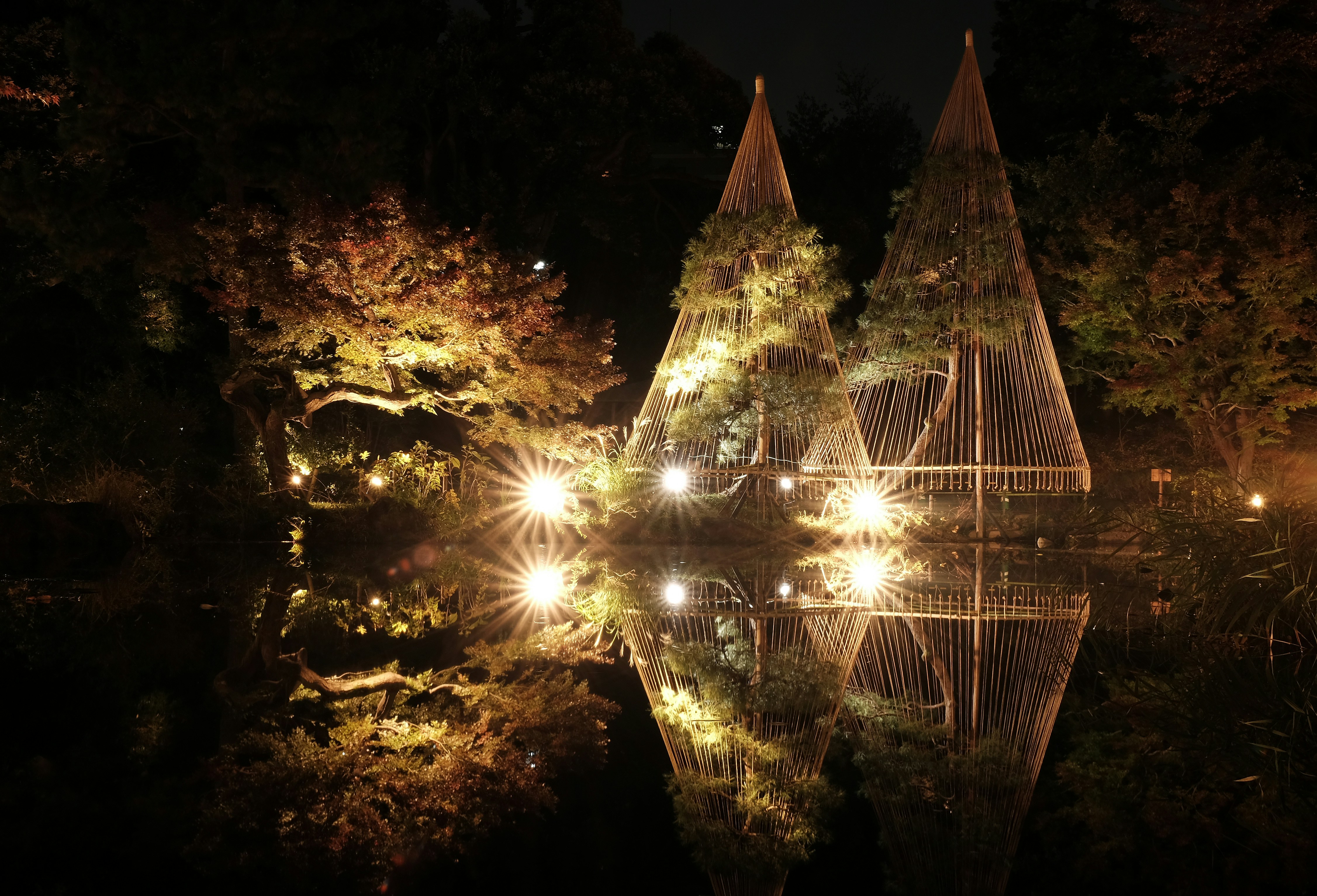 a reflection of lights in a pond at night