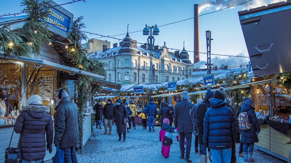 a group of people walking around a market