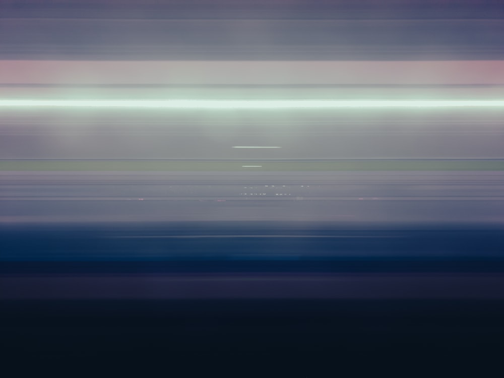 a blurry photo of a train traveling down the tracks