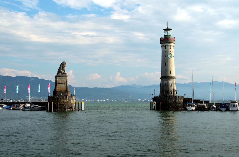 a light house sitting in the middle of a body of water