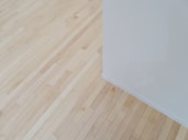 an empty room with hard wood floors and white walls