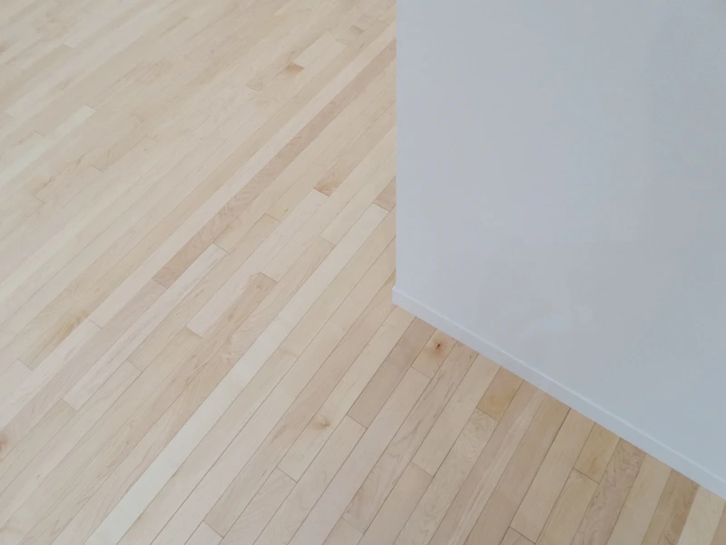 Interior room with new baseboard trim along hardwood floor