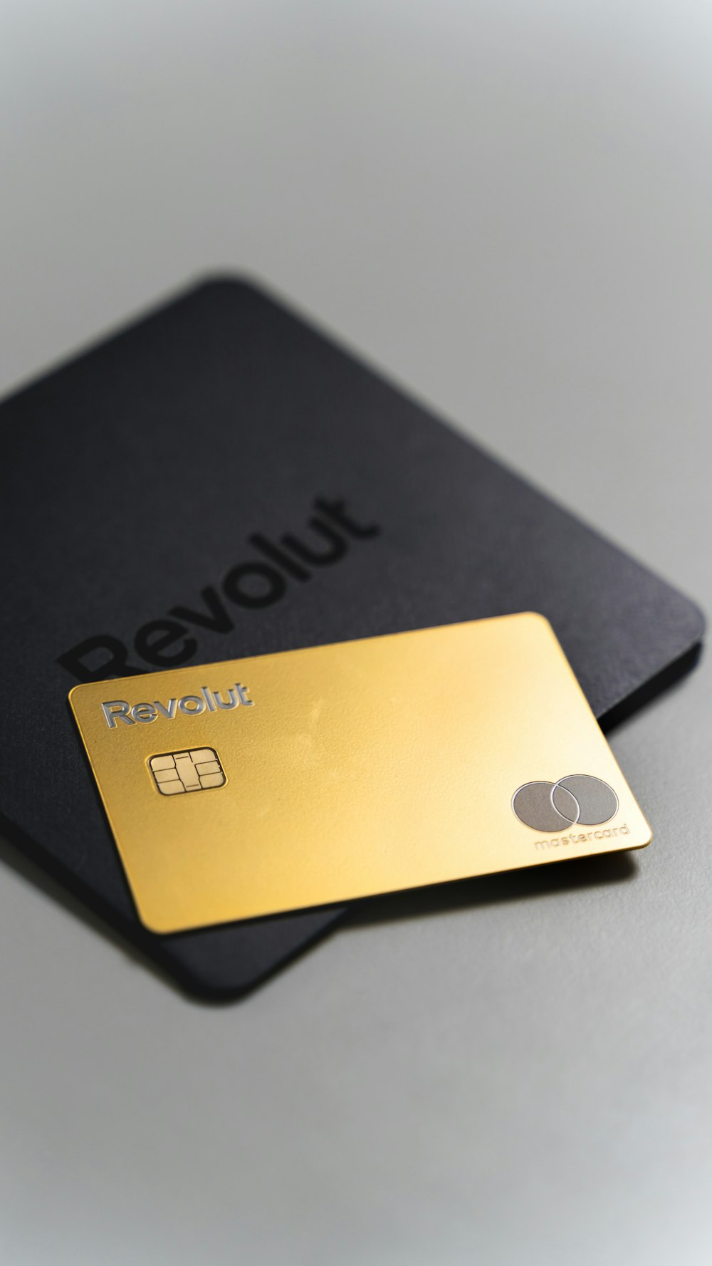a black and gold credit card sitting on top of a table