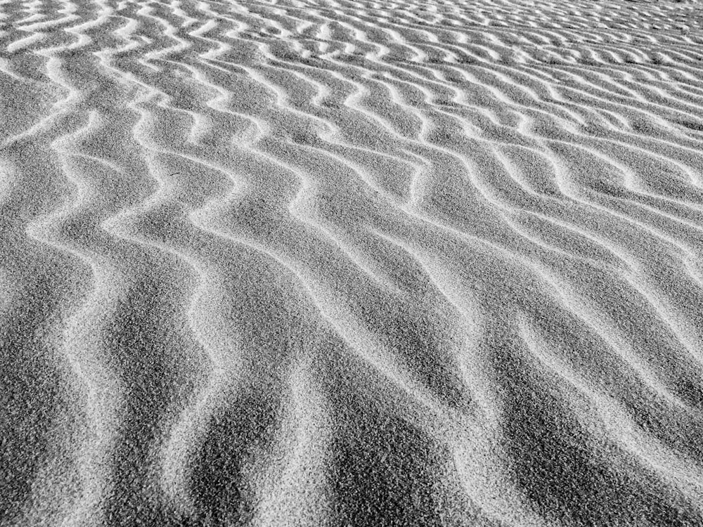 a black and white photo of a sand dune