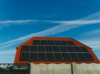 solar panes mounted on terracotta tile roof on top of a building