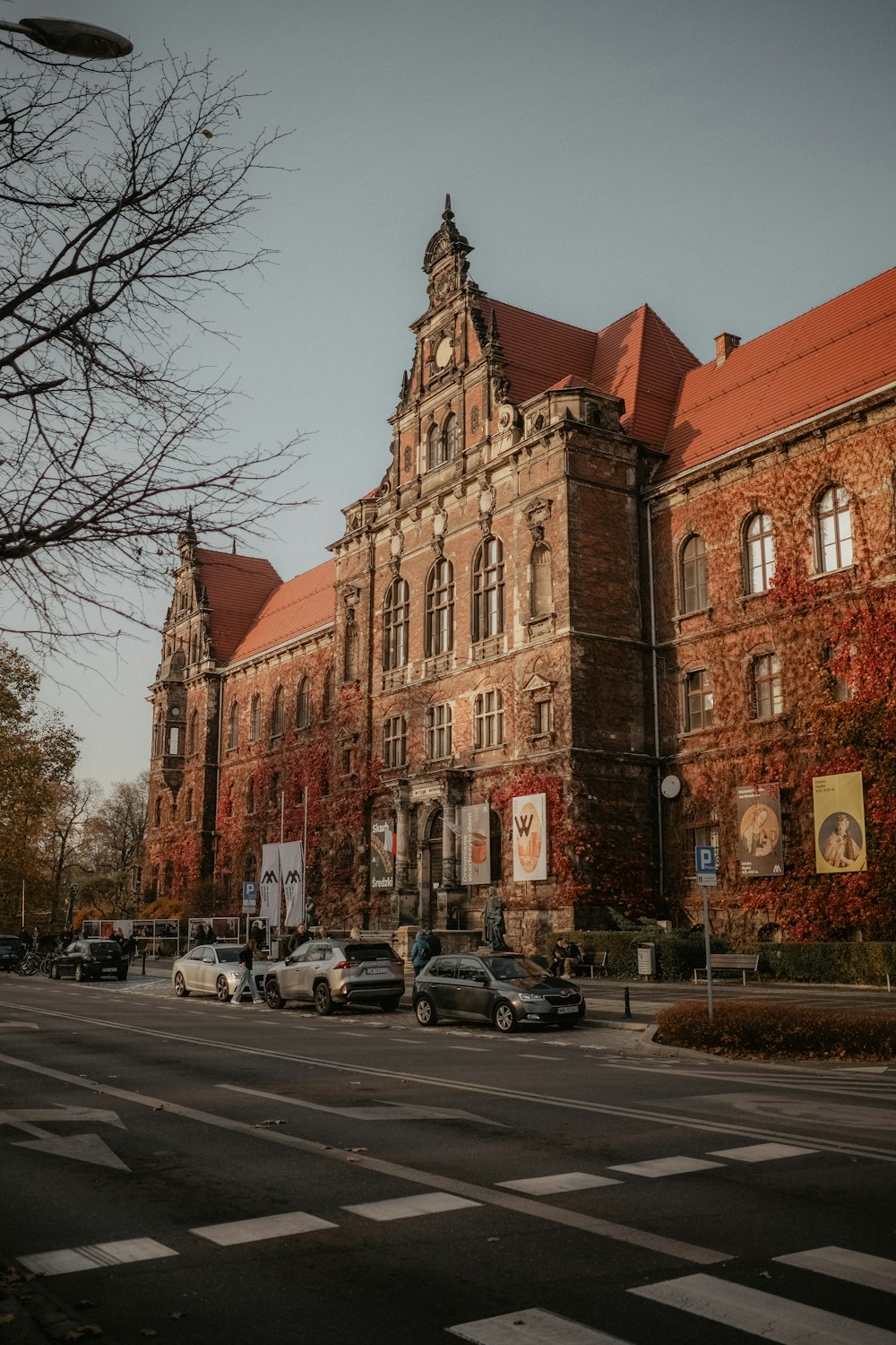 a large brick building with a red roof