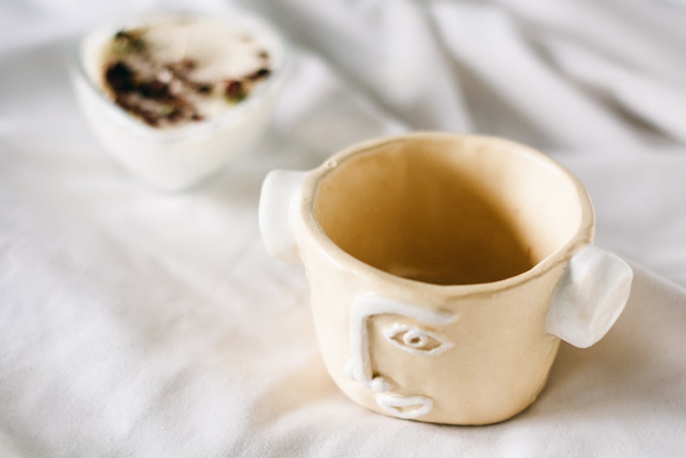 a close up of a cup on a bed