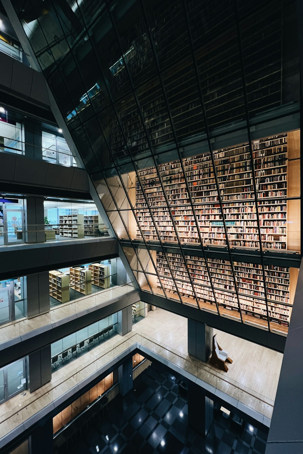 a person sitting on a bench in a library