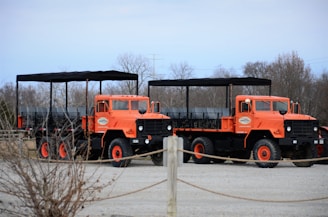a couple of orange trucks parked next to each other