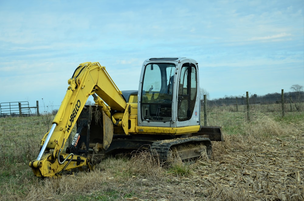 a yellow bulldozer is parked in a field