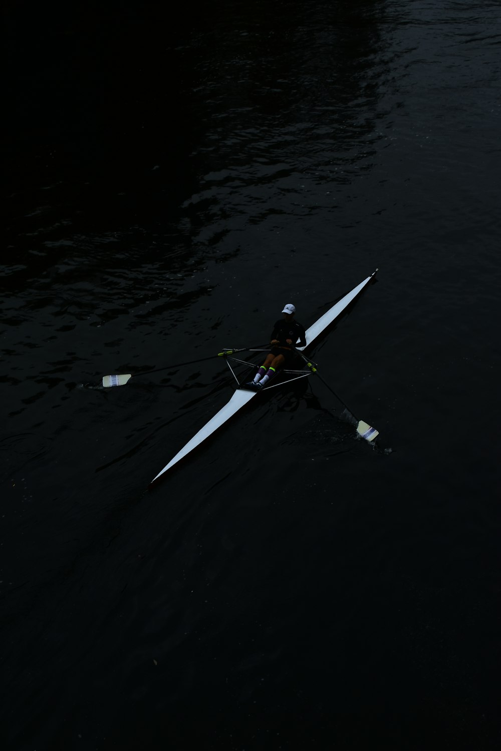 a person rowing a boat on a body of water