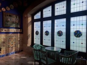 Artistic studio interior with colorful modernist stained glass inspired by Antoni Gaudí