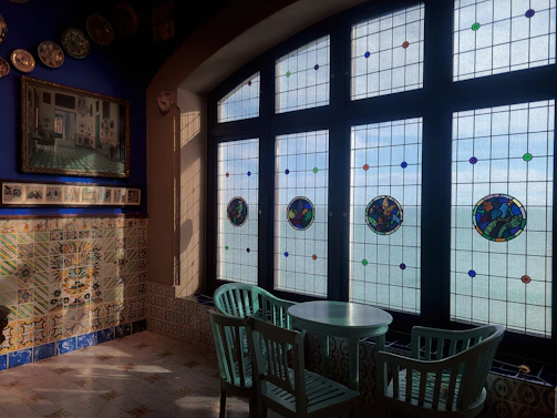 Artistic studio interior with colorful modernist stained glass inspired by Antoni Gaudí