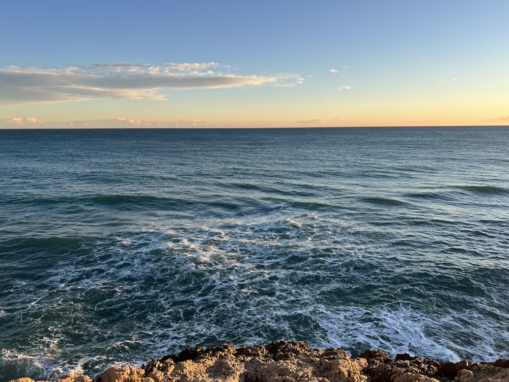 a view of the ocean from a rocky shore