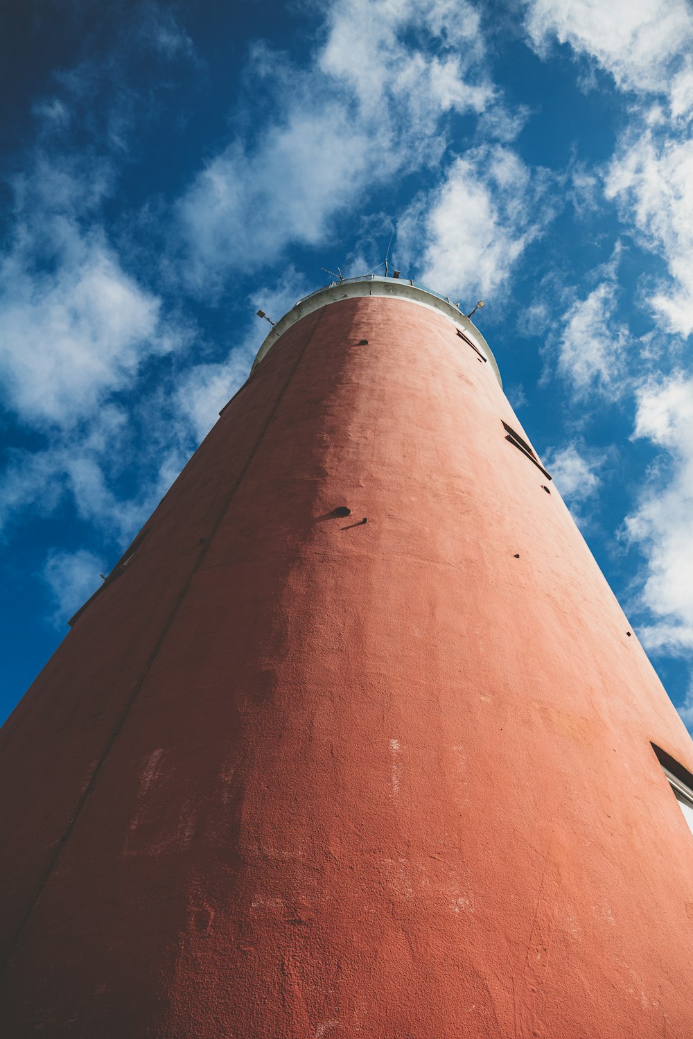 a tall red tower with a sky background