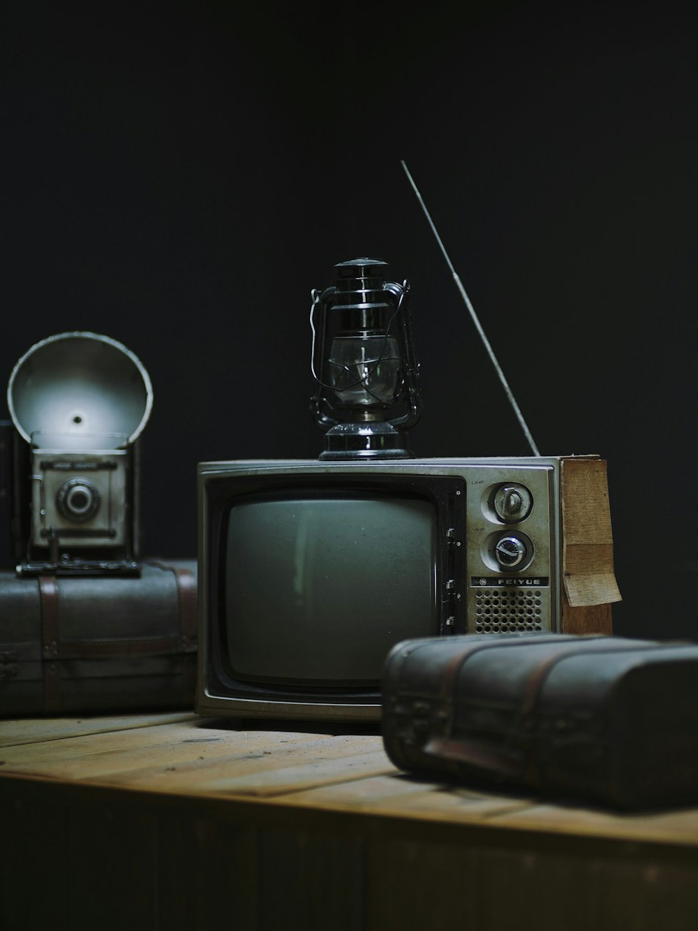 an old tv sitting on top of a wooden table