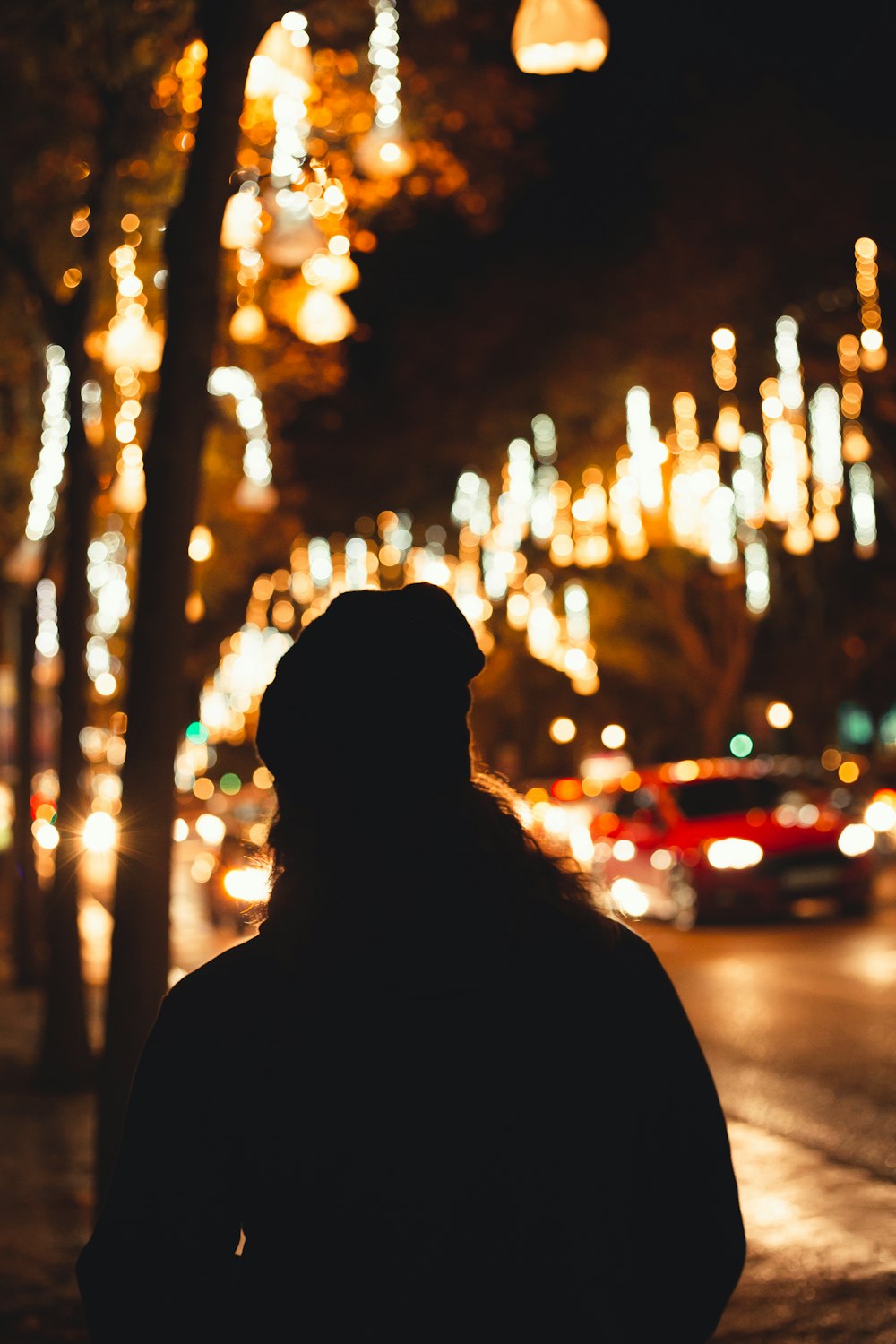 a person standing on a street at night