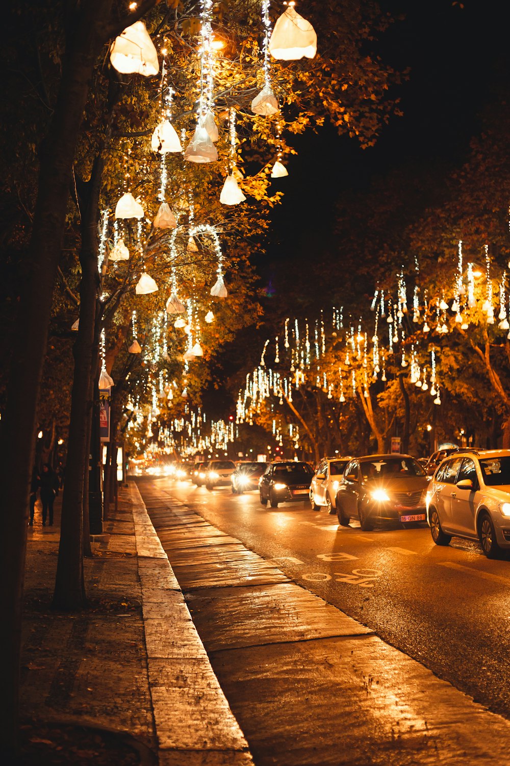 a street filled with lots of traffic next to tall trees