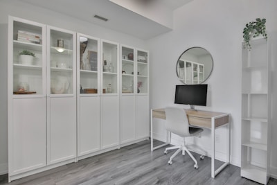 a white room with a desk and a mirror