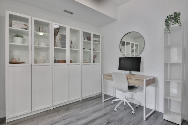 a white room with a desk and a mirror