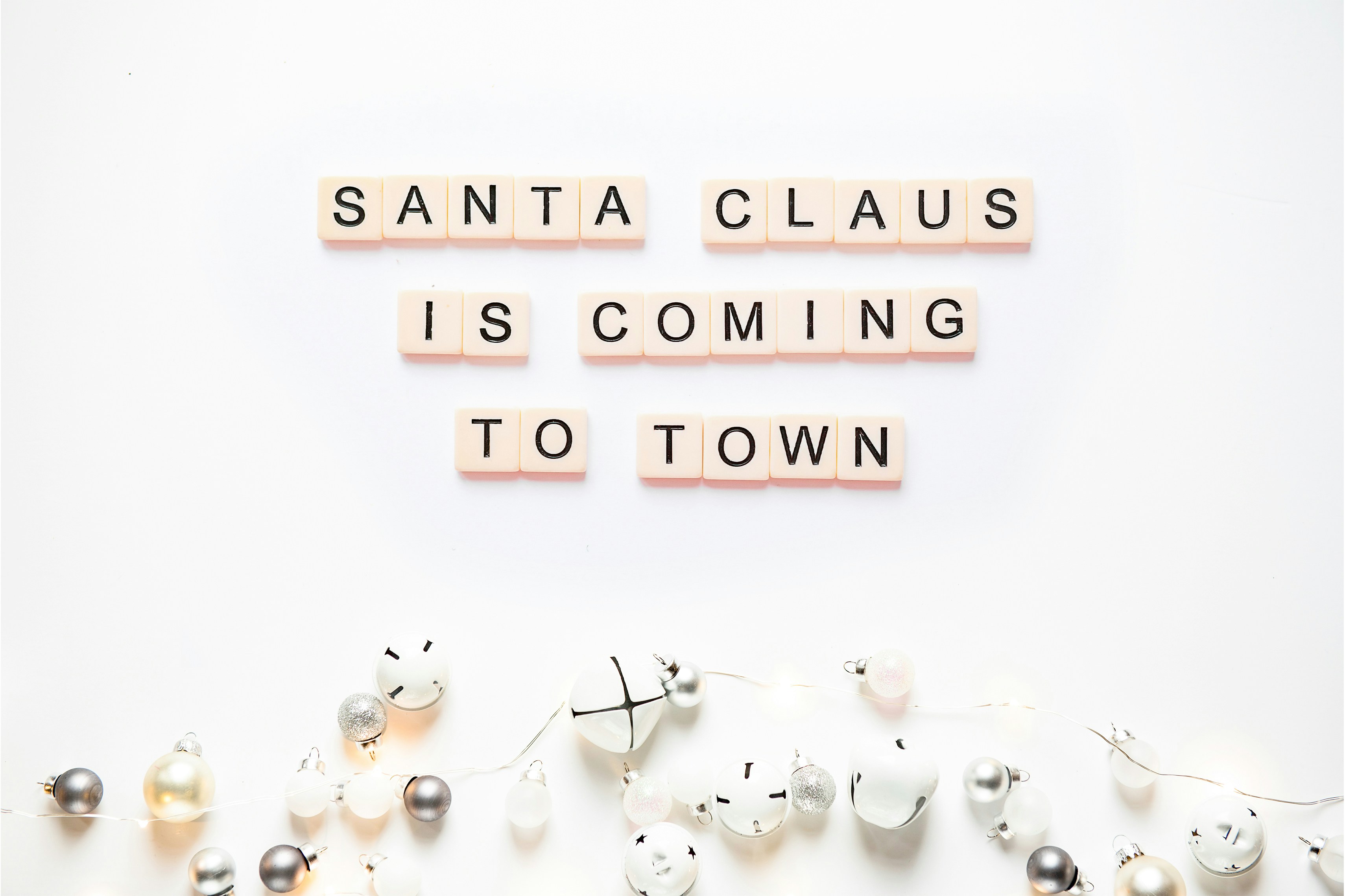 scrabble letters spelling santa claus is coming to town