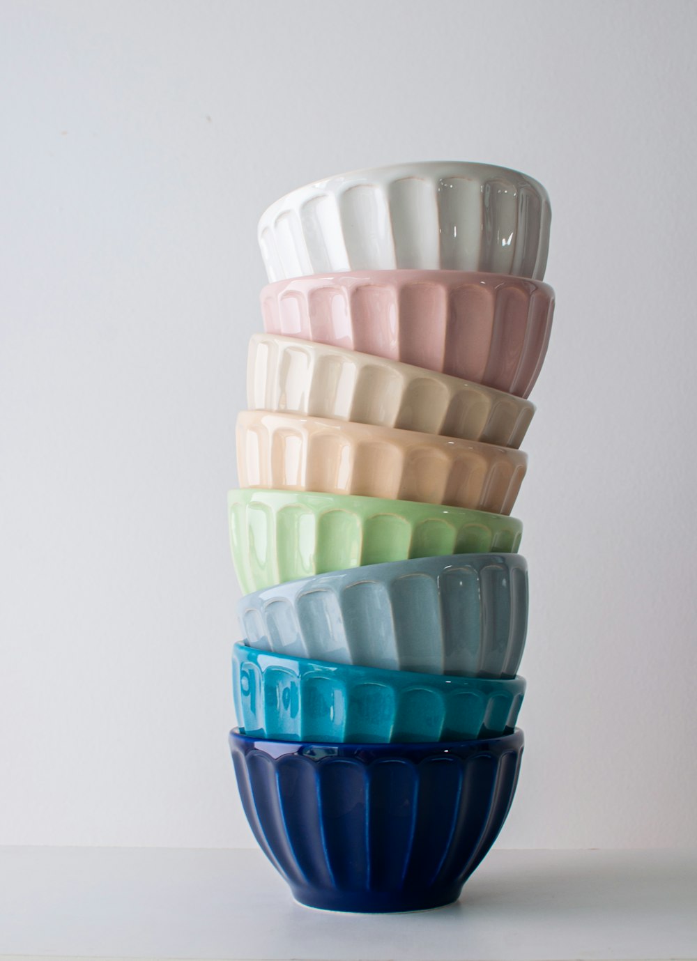 a stack of colorful bowls sitting on top of a table