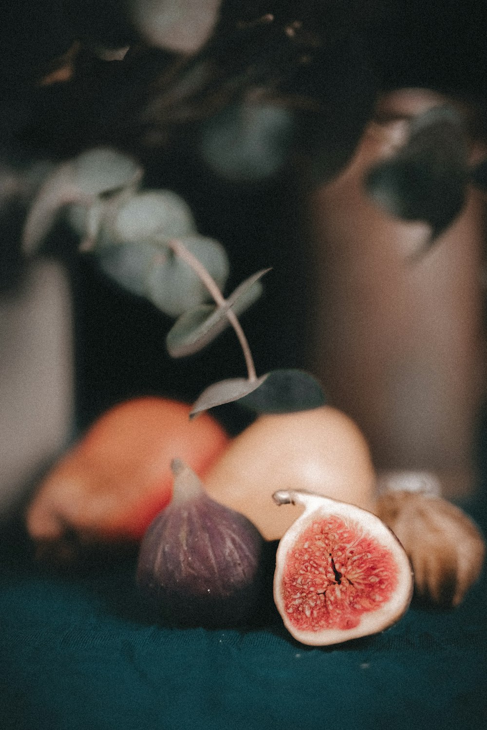 a figurine, figurine, and other fruit on a table